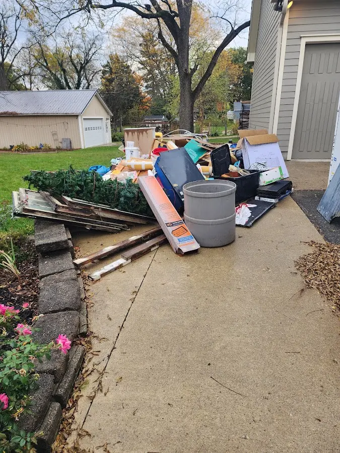 Dumpster being loaded with debris for Residential Dumpster Rental in East Lansing